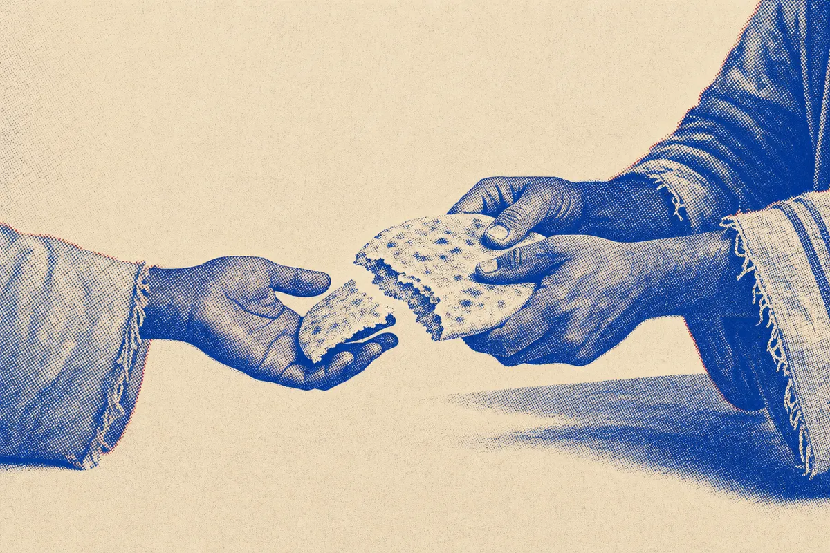 Two hands breaking bread