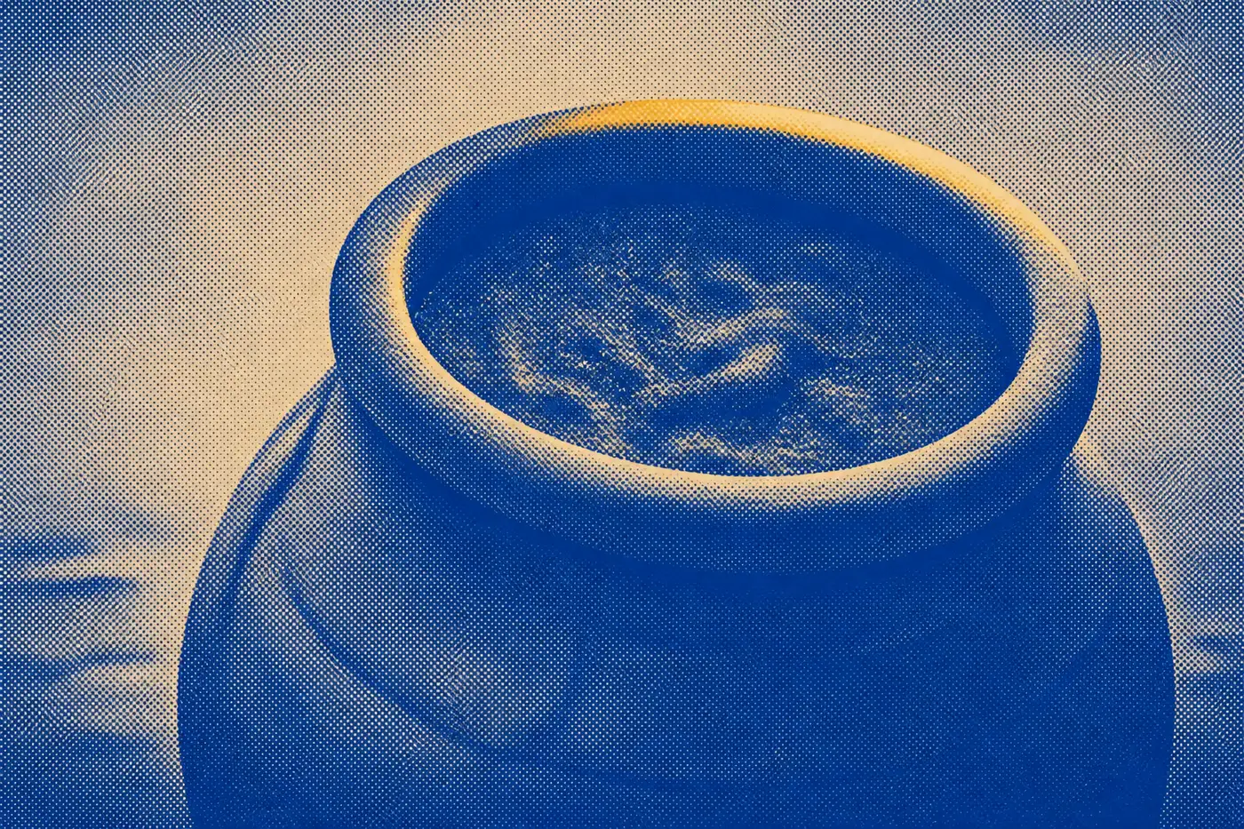 The mouth of a rough clay storage jar seen close and from below, the portion kept inside it spoiled by morning.