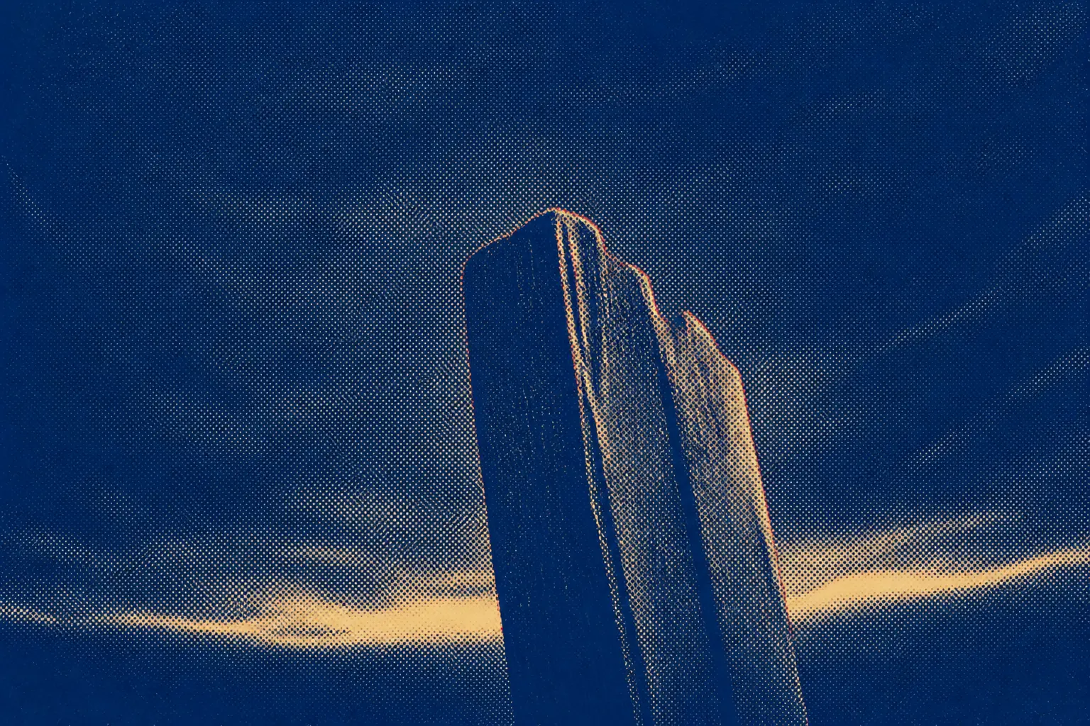A rough wooden upright against a darkened sky, seen from below, with a low band of stormlight behind it.
