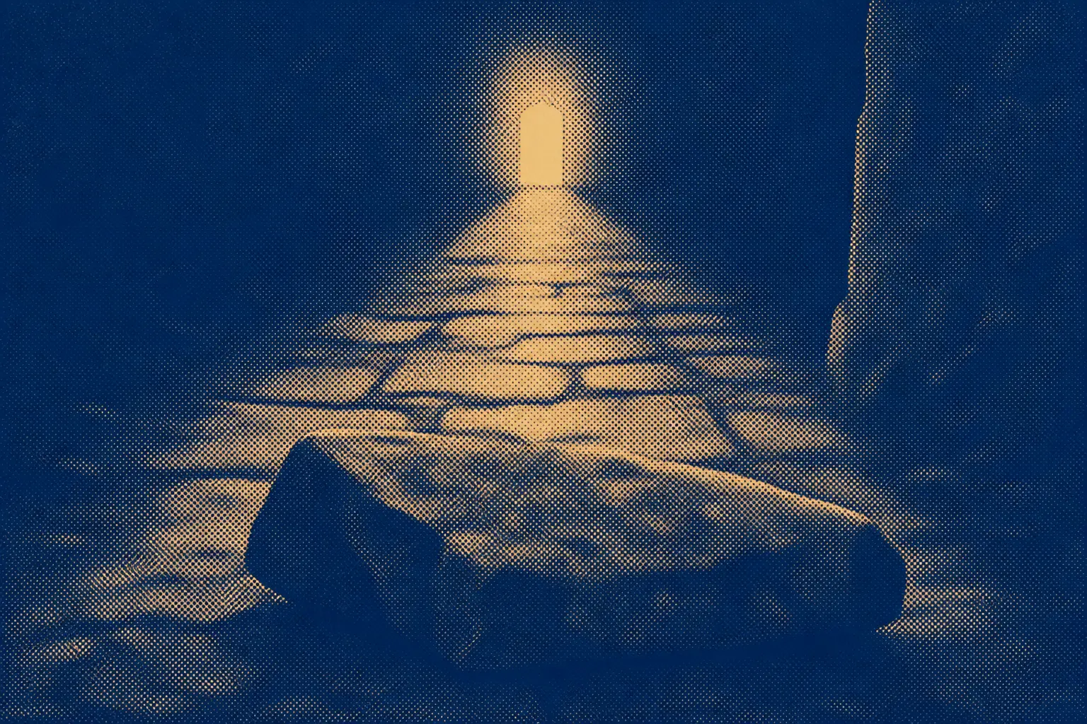 A narrow stone road running through darkness toward a distant lit gate, one large stone lying across it in the foreground.