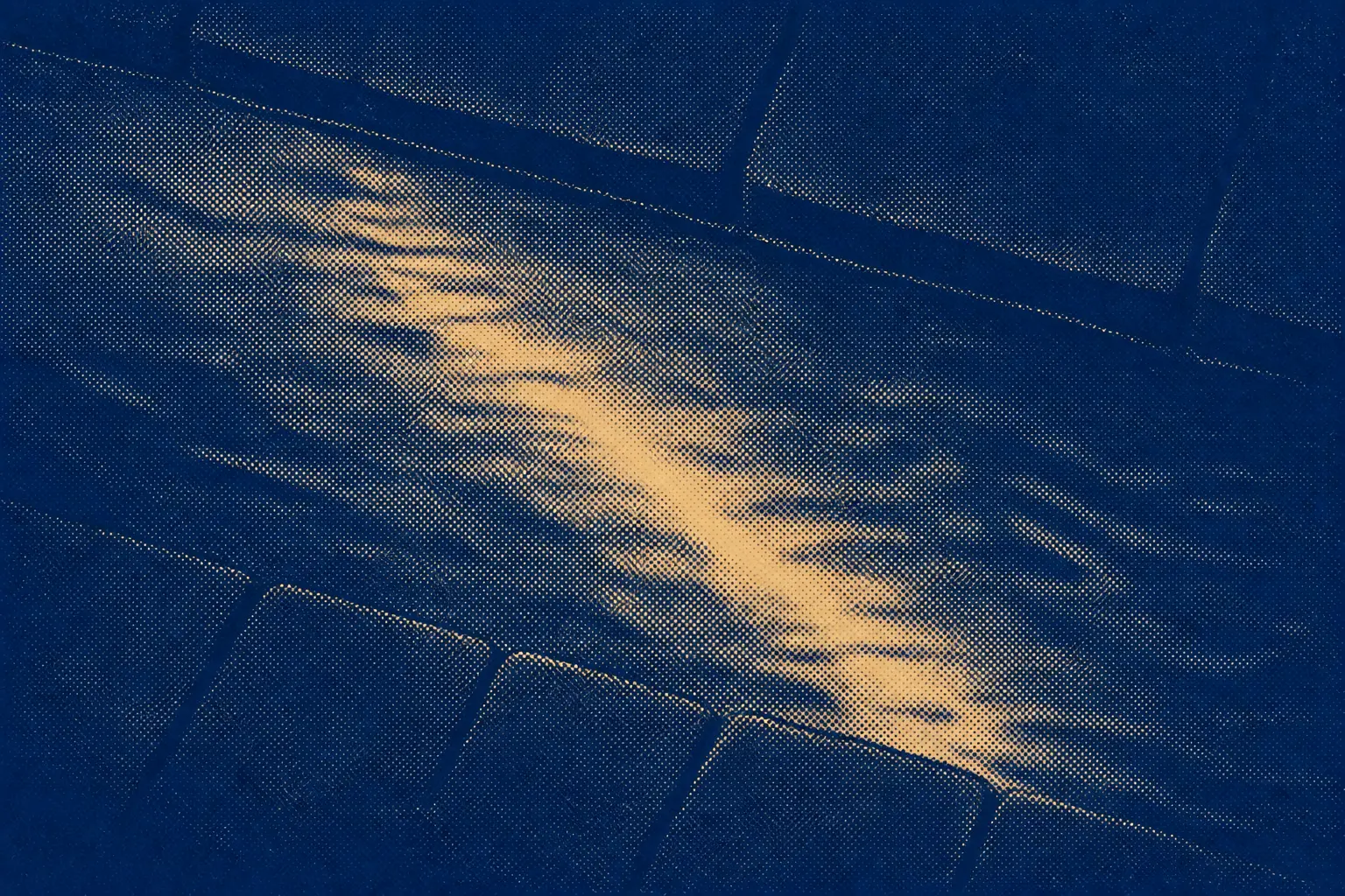 Still clear water in a stone channel, catching a single band of warm light on its surface.
