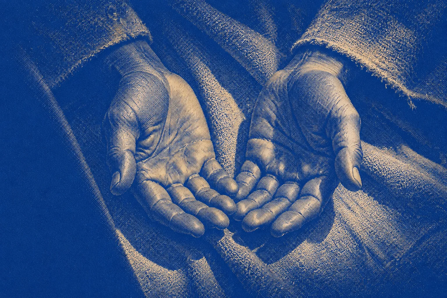 A pair of open hands resting palm-up and still on a lap, fingers relaxed, no object held